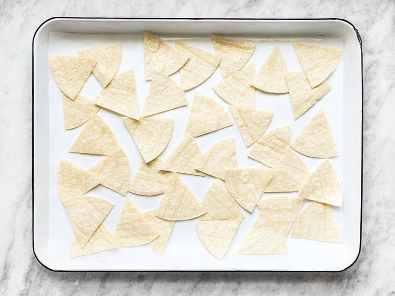 Spread oiled tortillas onto a baking sheet