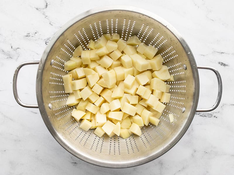 Diced potatoes in a colander