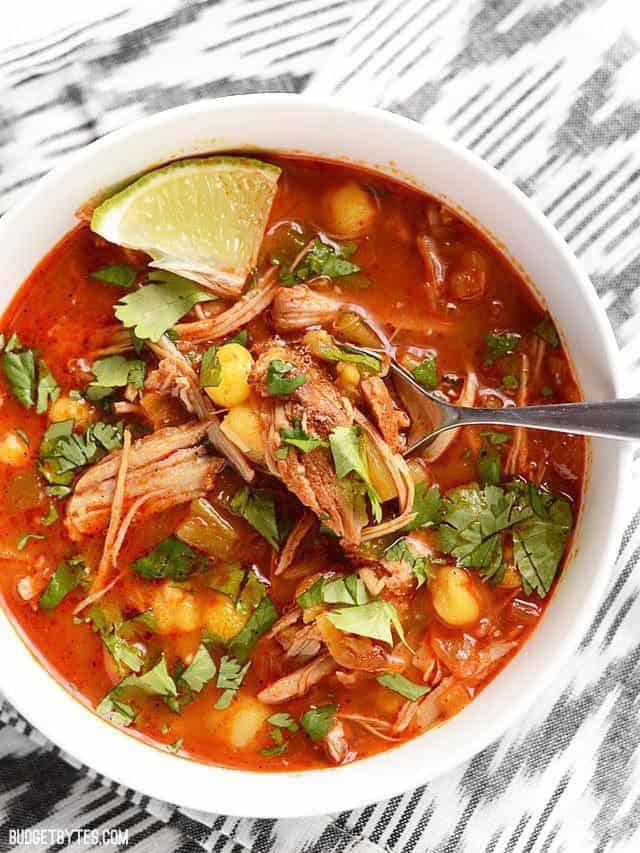 Close up view of 30 minute posole with lime and cilantro toppings. 