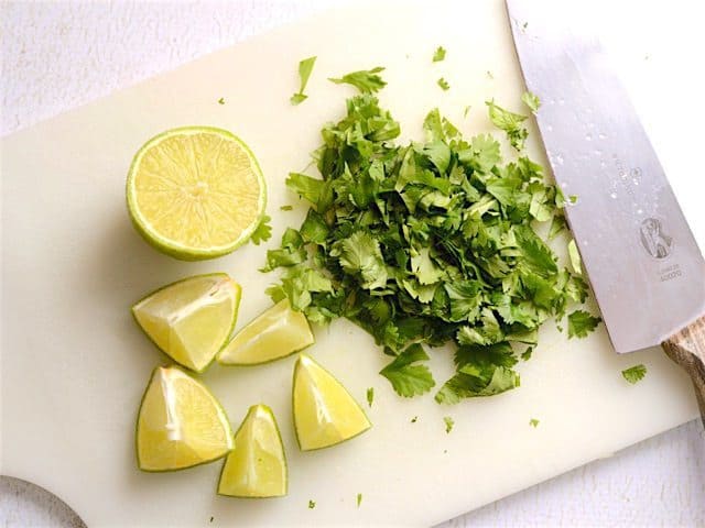 Cilantro and Lime on a cutting board with a knife