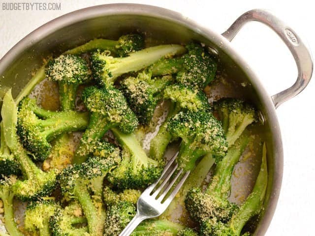 Overhead view of a skillet with Garlic Parmesan Broccoli, a fork in the center