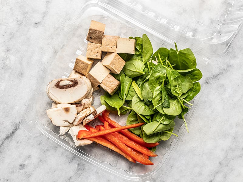 Salad Bar Vegetables in a take-out container with tofu.