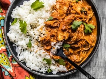 This Slow Cooker Chicken Tikka Masala boasts a rich and aromatic sauce, and tender juicy chicken. Make four servings for the price of one take out! Budgetbytes.com