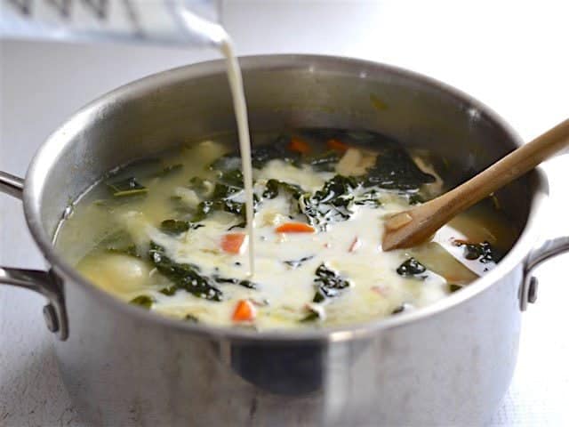 Half and Half being poured into the chicken gnocchi soup