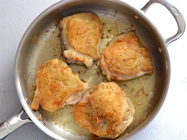 Browned Chicken Thighs in the skillet