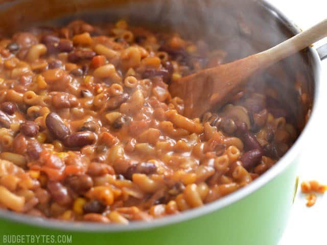 Side view of vegetarian chili mac in the pot, with steam rising off the surface