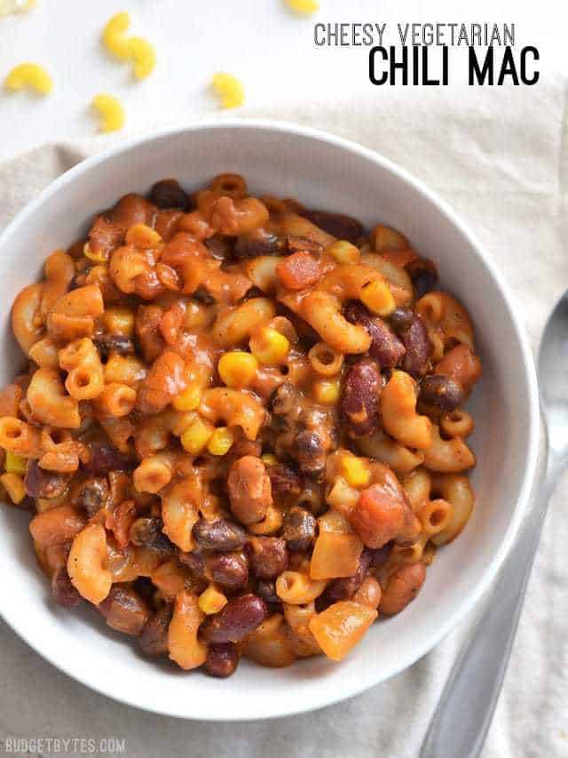 Close up overhead view of a bowl full of vegetarian chili mac with the title text in the top right corner.