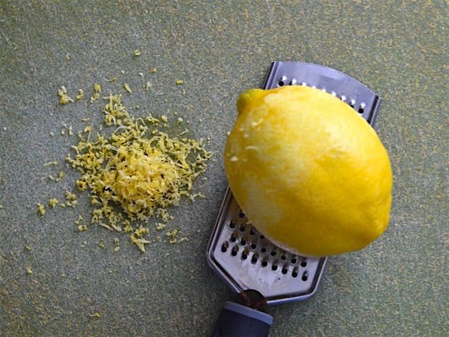 zested lemon sitting on a microplane