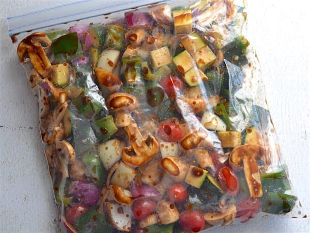 Chopped vegetables marinating in a large zip top bag