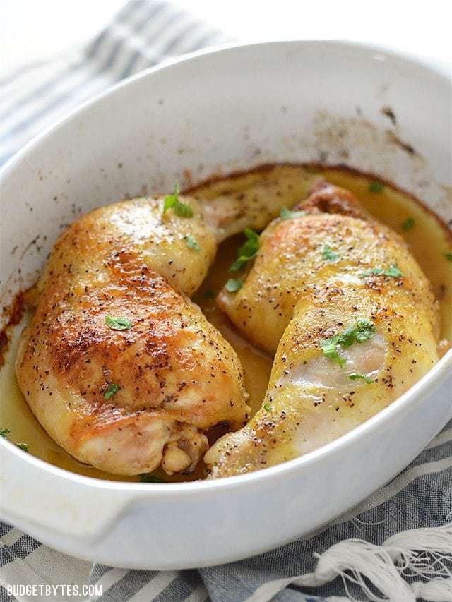 Front view of Oven Roasted Chicken Legs in a white casserole dish