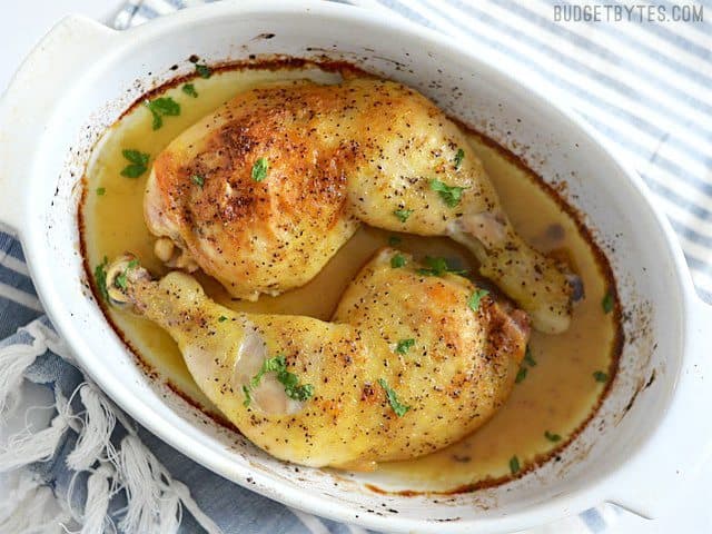 Bird's eye view of Oven Roasted Chicken Legs in a white casserole dish.