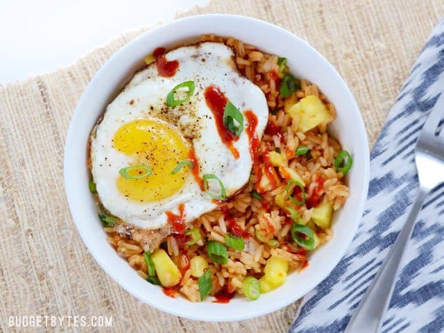 Overhead view of a Pineapple Sriracha Breakfast Bowl on a natural fiber napkin