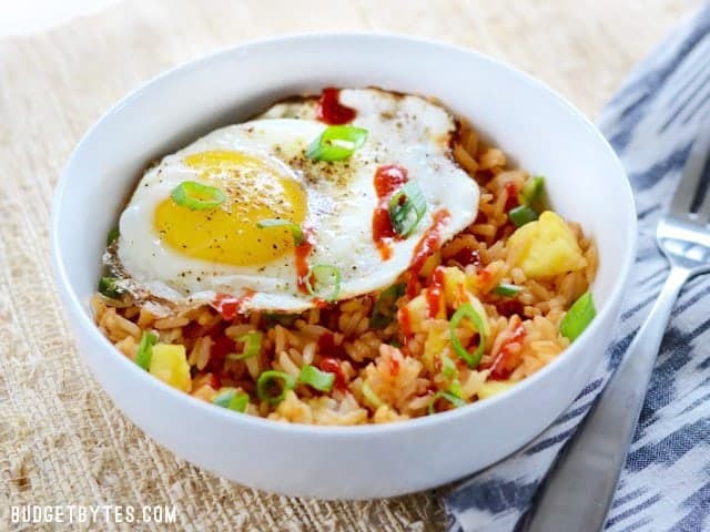 Side view of a finished Pineapple Sriracha Breakfast Bowl, fork on the side