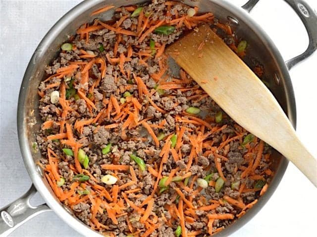 Onion and carrot added to the skillet with beef
