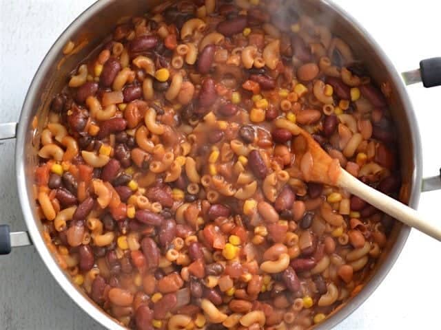 Simmered Chili Mac in the pot overhead view, wooden spoon in the pot