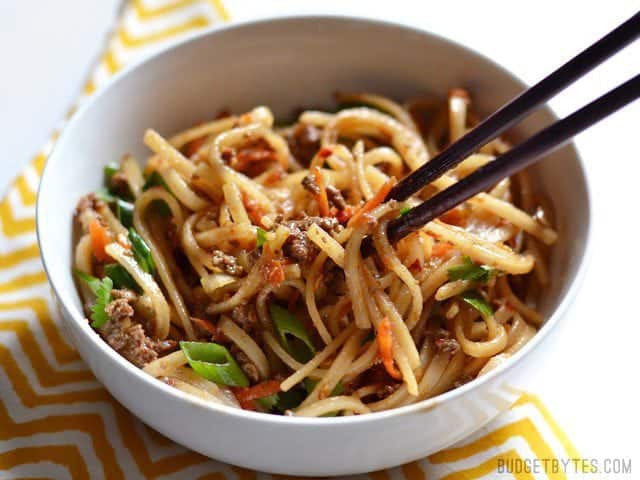 Beef Stir Fry Noodles in a bowl, chopsticks lifting a bite