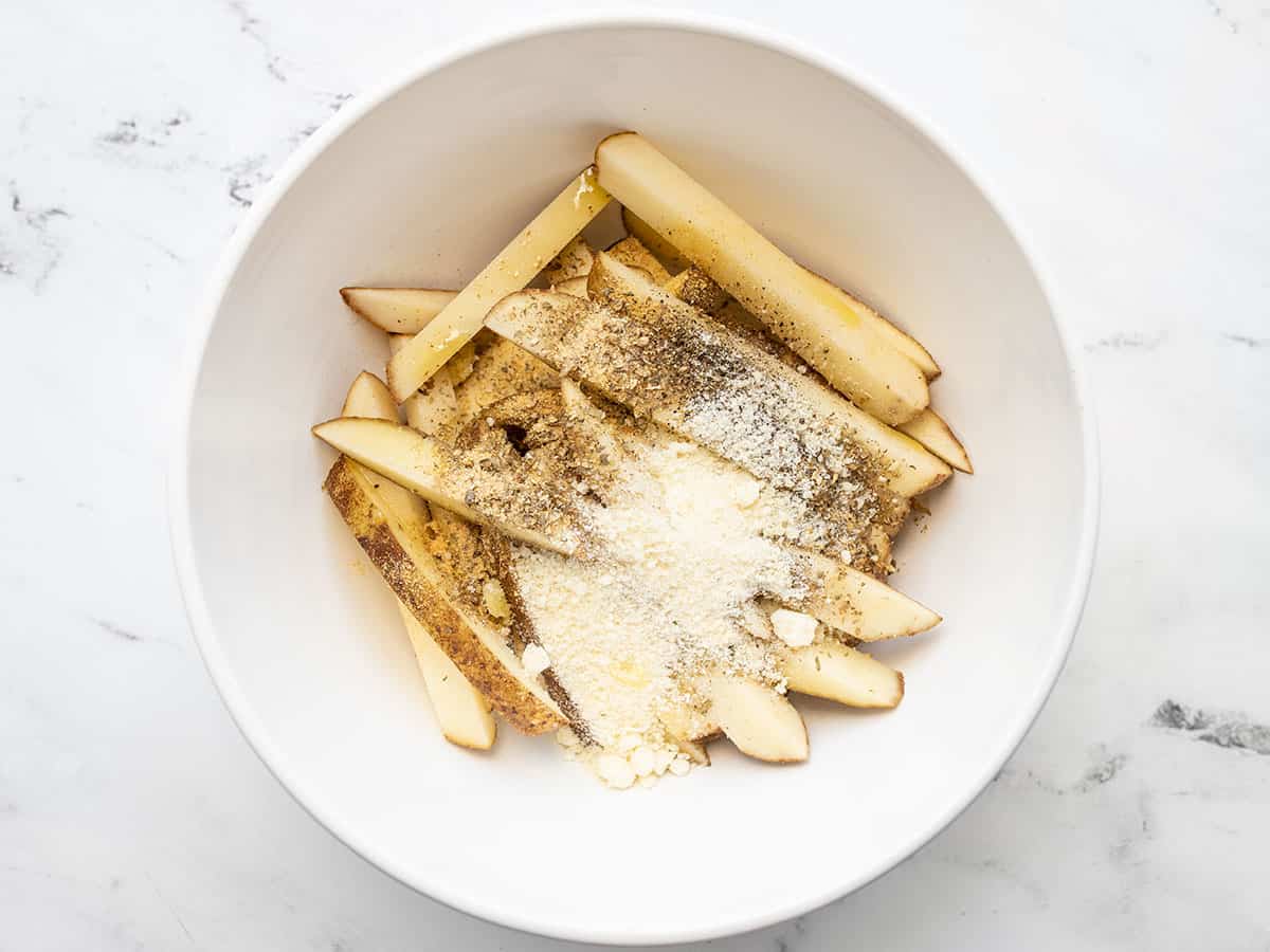 Cut potatoes in a bowl with seasoning