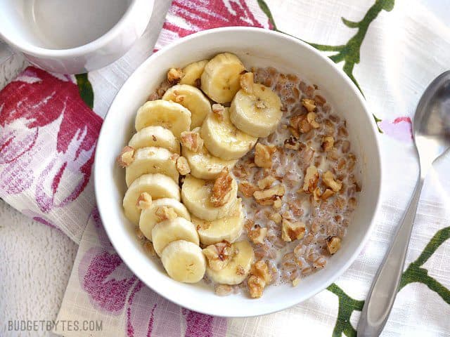 A bowl of Banana Nut Breakfast Farro with banana and walnuts, ready to be eaten