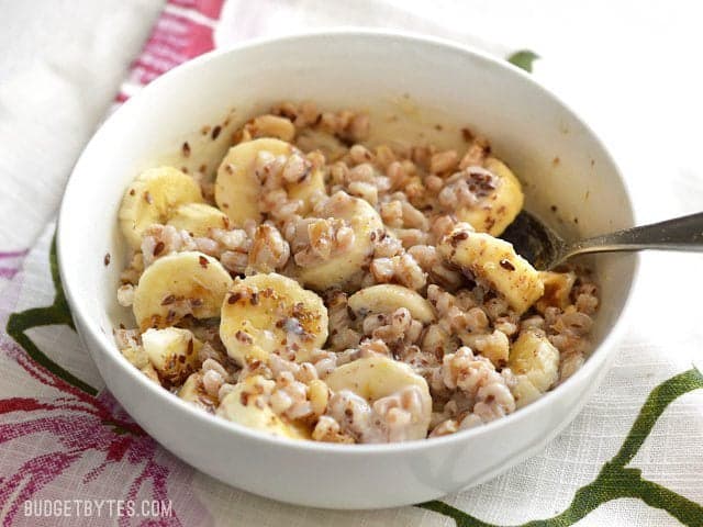 A bowl of Banana Nut Breakfast Farro with bananas and nuts, all mixed together