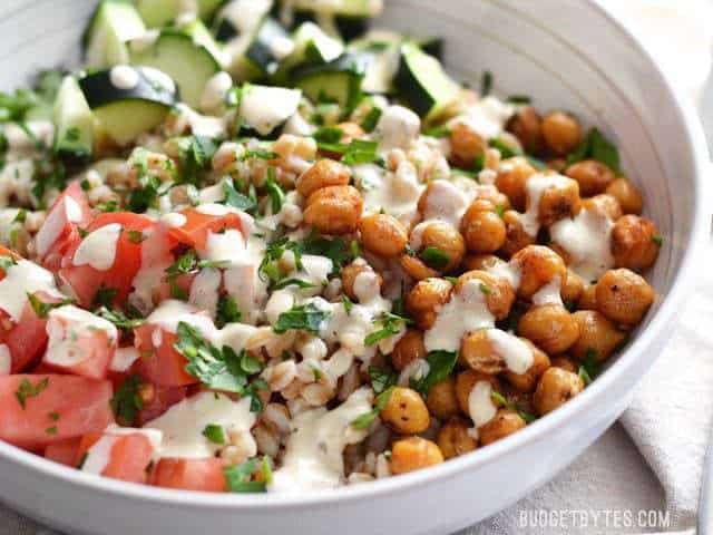 Close up side view of a bowl full of Mediterranean Farro Salad 