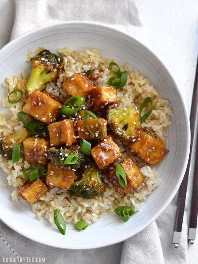 Overhead view of Pan Fried Sesame Tofu with Broccoli in a white bowl. 