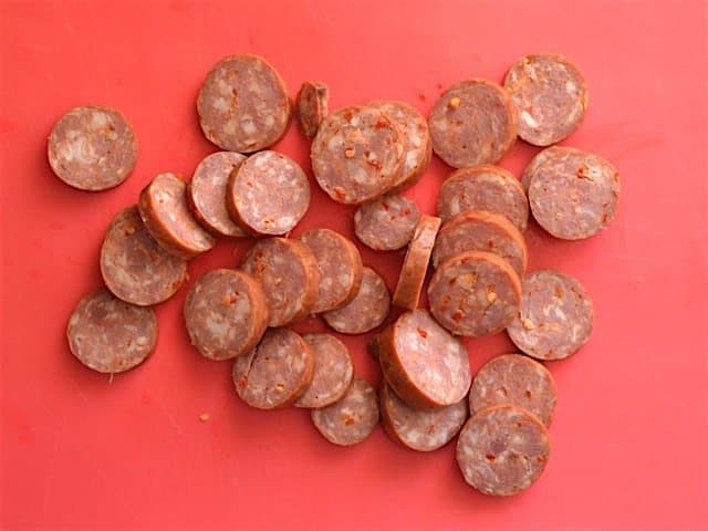 Sliced Smoked Sausage on a red cutting board