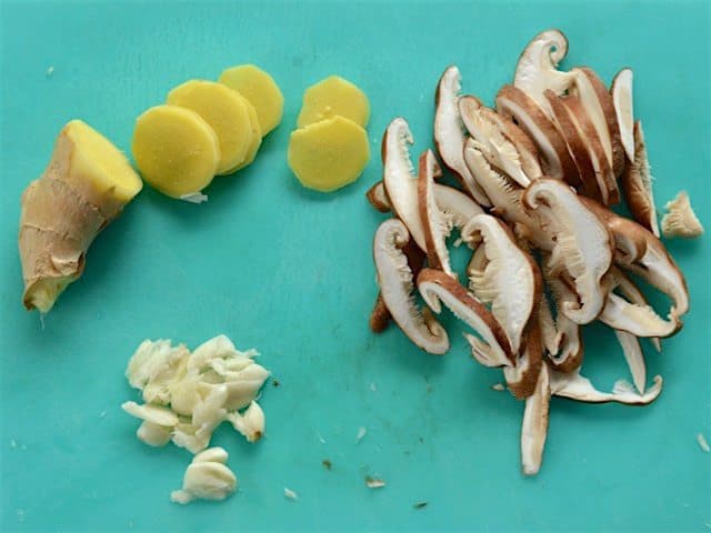 Ginger, Garlic, and Shiitake mushrooms on a cutting board