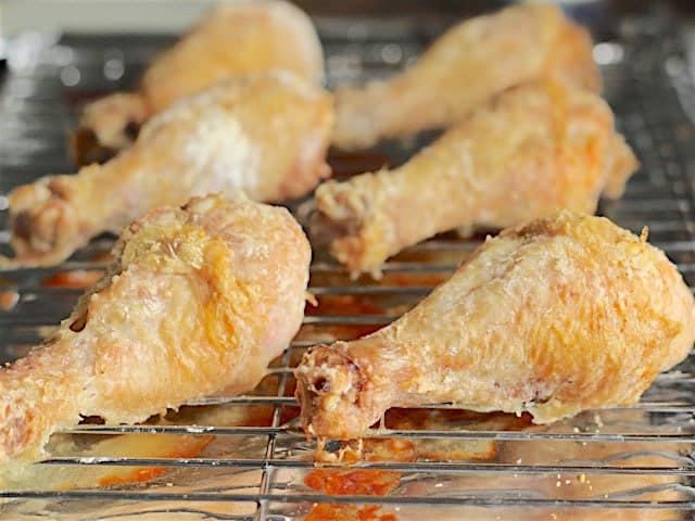 Close up side view of the Golden Baked Chicken Drumsticks on the wire rack