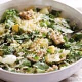 Kale and salmon Caesar salad served in a bowl.