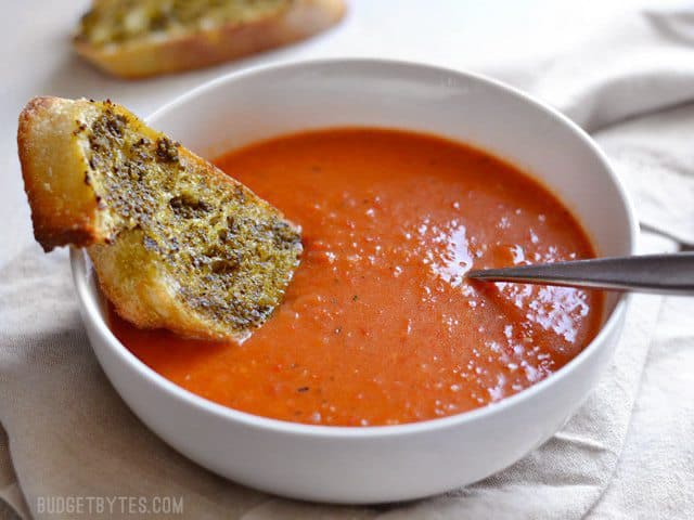 Roasted Red Pepper and Tomato Soup is a fast and rich weeknight comfort food perfect for dipping crusty bread or grilled cheese. - BudgetBytes.com