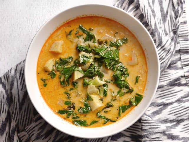 Thai Curry Vegetable Soup added to bowl with noodles