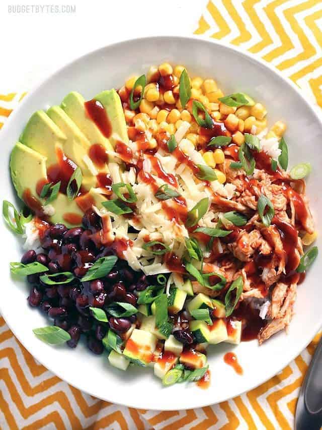 Overhead view of a BBQ Chicken Burrito Bowl on a yellow zig zag striped napkin