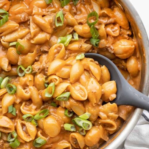 Close up of cheeseburger pasta skillet being scooped out with a spoon