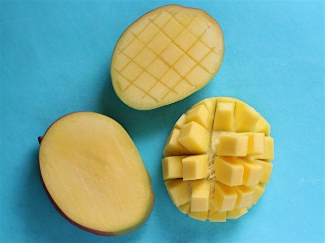 Cubed Mangoes on a blue cutting board