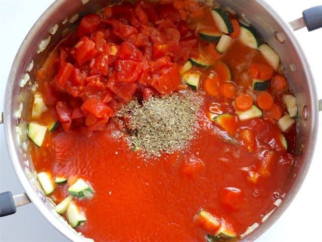 Diced Tomatoes and Tomato Sauce added to soup pot