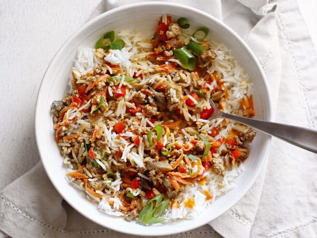 Stirred up bowl of hoisin stir fry, a fork stuck in the middle