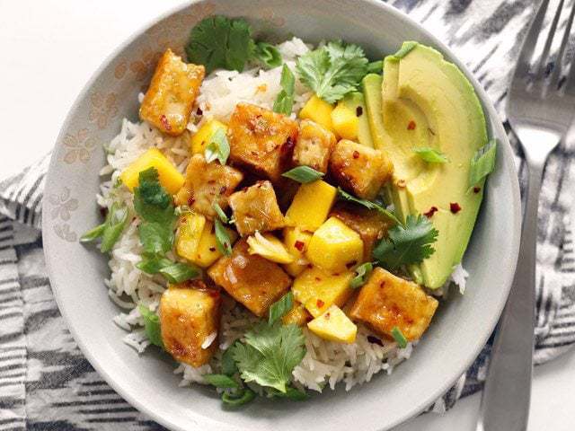 Finished Mango Coconut Tofu Bowl viewed from above, sitting on a striped napkin