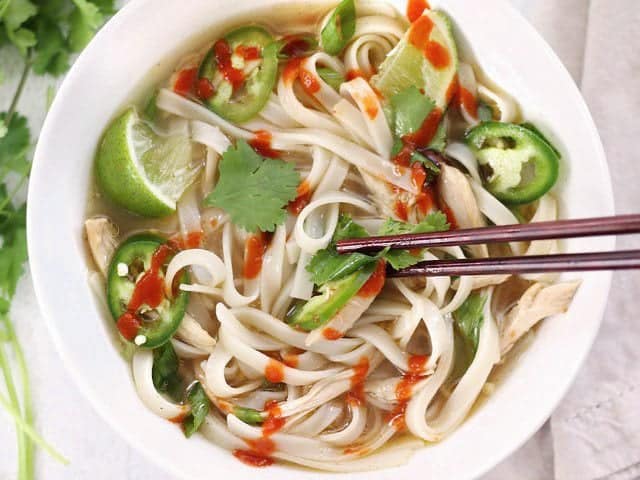 Bowl full of Quickie Faux Phở with chopsticks in the center picking up a bite