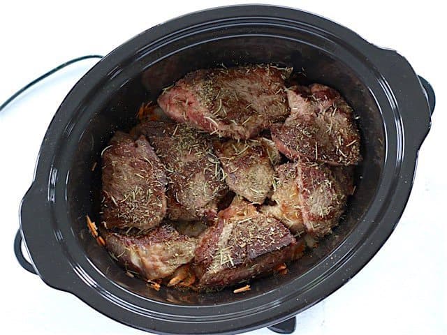 Browned Beef and Herbs added to other ingredients in slow cooker 