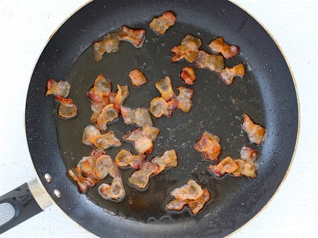 Cooked Bacon pieces in a skillet