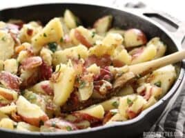 German Potato Salad is coated in a tangy bacon vinaigrette and is the perfect side for all your summer grilling. BudgetBytes.com