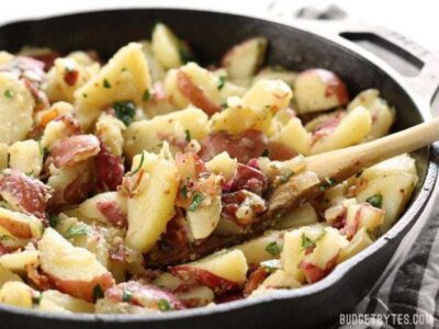 German Potato Salad is coated in a tangy bacon vinaigrette and is the perfect side for all your summer grilling. BudgetBytes.com