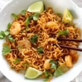 Lime shrimp dragon noodles coriander and lime with chopsticks.