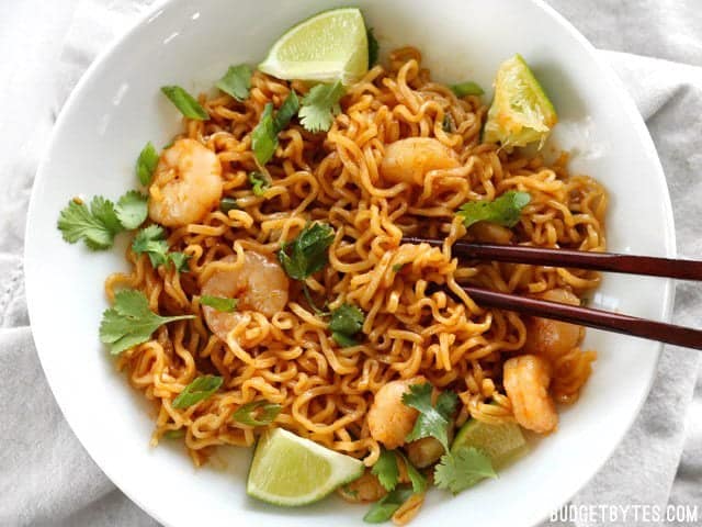 Overhead view of a bowl full of Lime Shrimp Dragon Noodles with chopsticks
