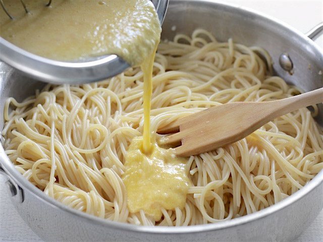 Pour Egg Parmesan Mixture over spaghetti in the skillet