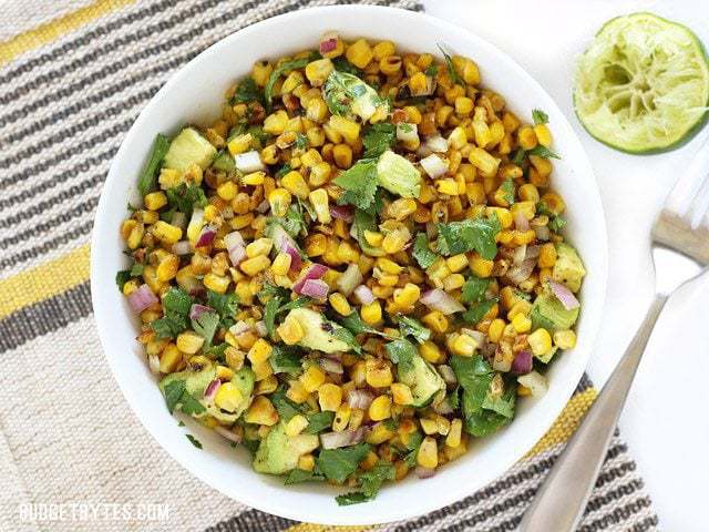 Overhead view of a bowl full of Warm Corn and Avocado Salad 