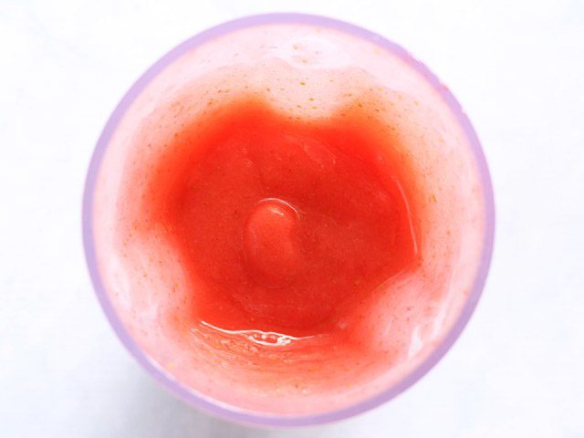 Blended Strawberry Rosé Slush in the blender