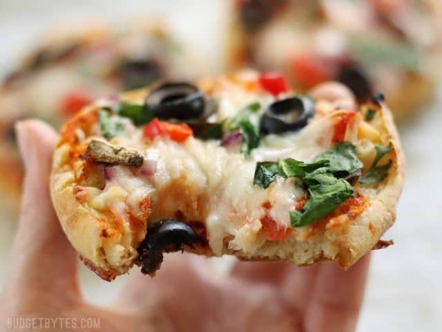 Close up of a baked Freezer Ready Mini Pizza with a bite taken out