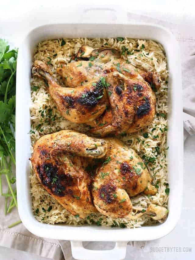 Overhead view of a rectangular casserole dish with pressure cooked rice and chicken halves.