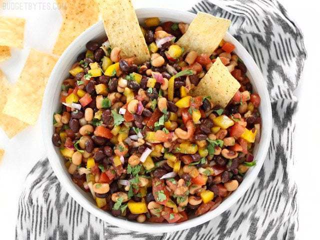 Overhead shot of a bowl of Cowboy Caviar with tortilla chips